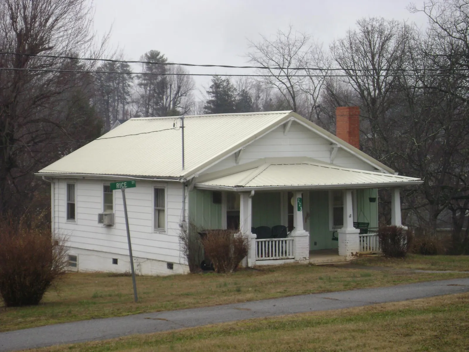 White metal roof on a craftsman bungalow at a street corner in Columbia City